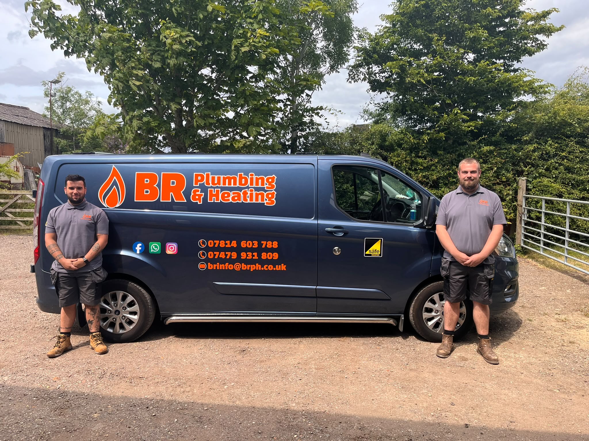 The chrome-blue BR Plumbing and Heating van with orange lettering, and two engineers standing beside it